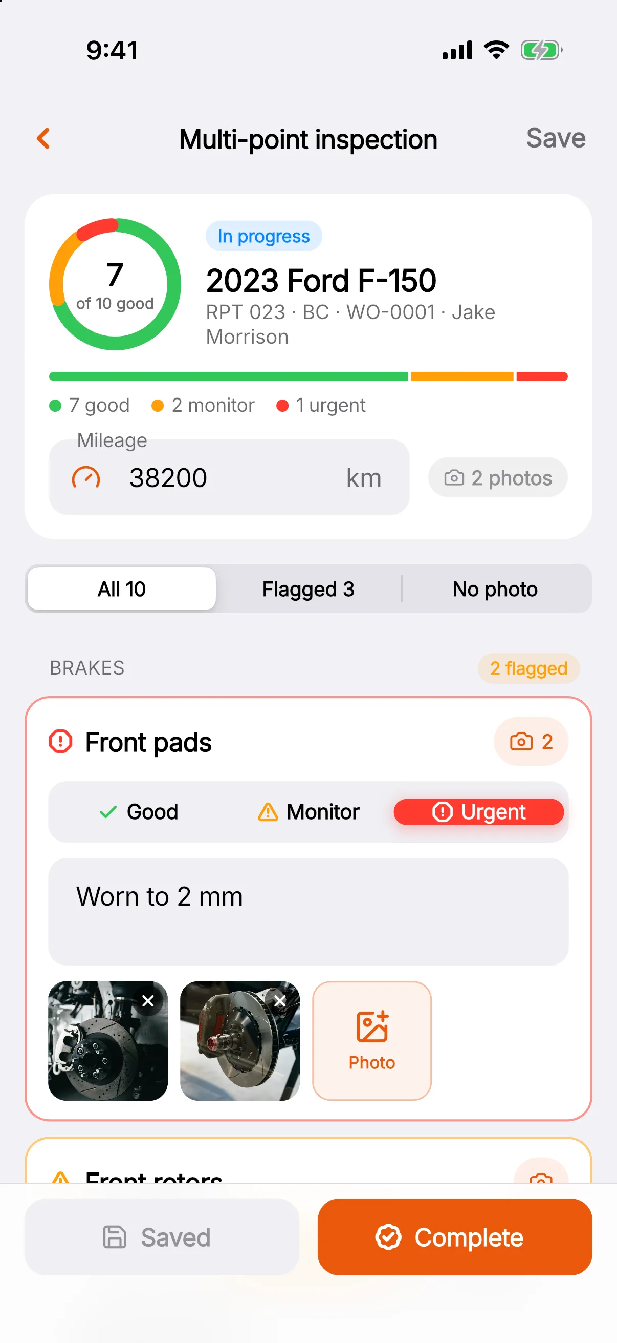 A multi-point inspection on a 2023 Ford F-150: 7 of 10 items good, 2 to monitor and 1 urgent, with front pads marked urgent, a note and two brake photos