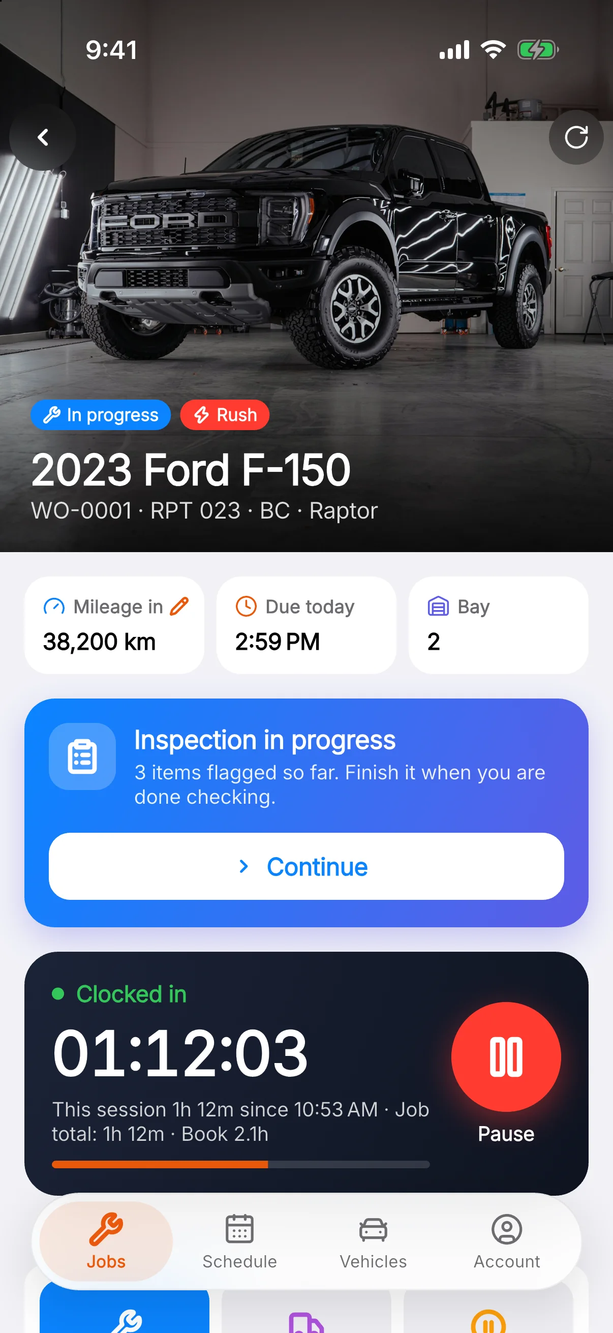 A job on the technician app: a 2023 Ford F-150 marked rush, with mileage, due time, bay, an inspection in progress and the job clock running