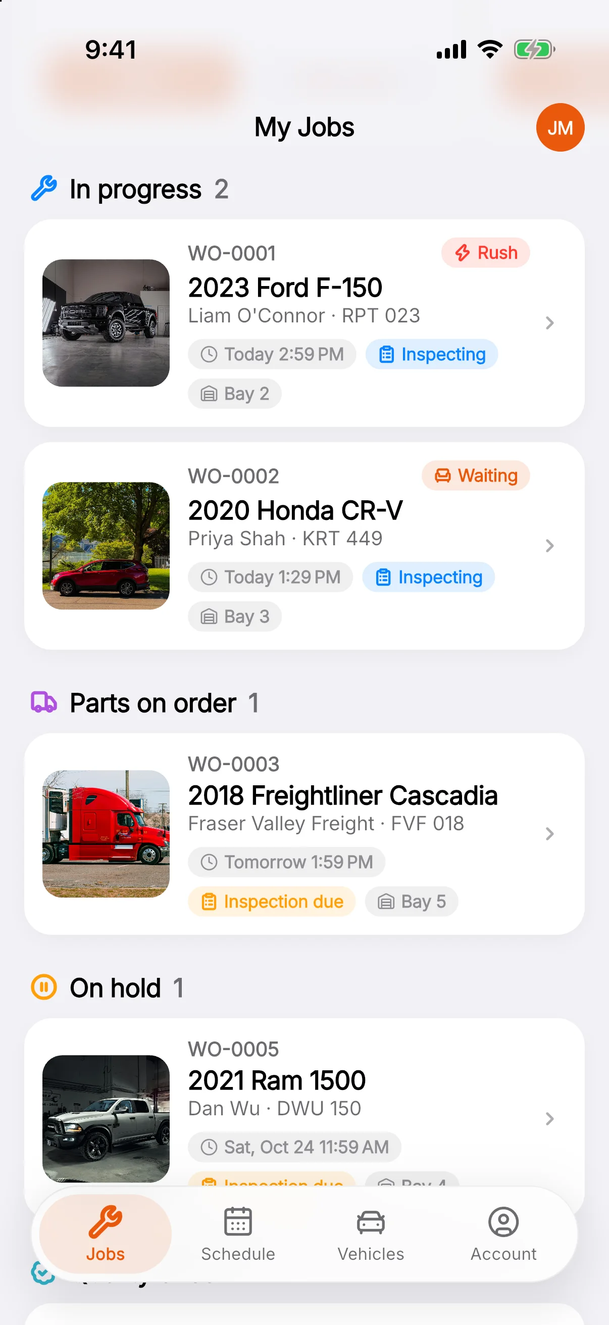 My Jobs on the technician app: a 2023 Ford F-150, 2020 Honda CR-V, 2018 Freightliner Cascadia and 2021 Ram 1500 grouped by status, each with its photo, due time and bay